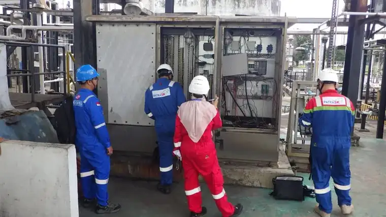 Field team inspecting a wastewater monitoring panel at PT Patra SK Dumai